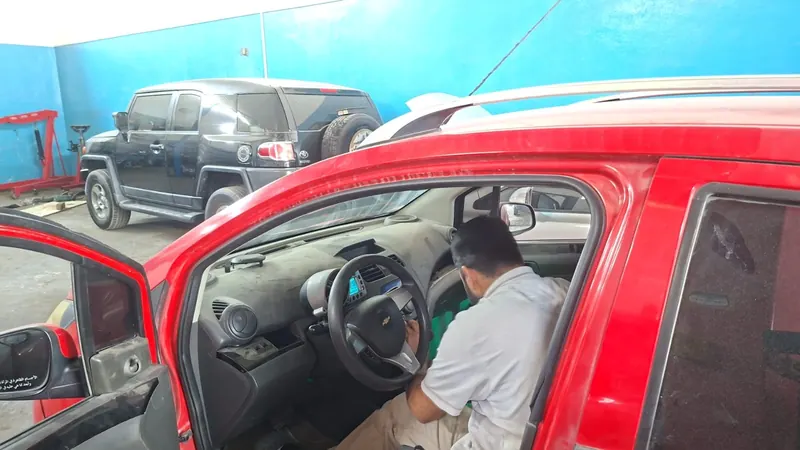 Technician repairing dashboard wiring