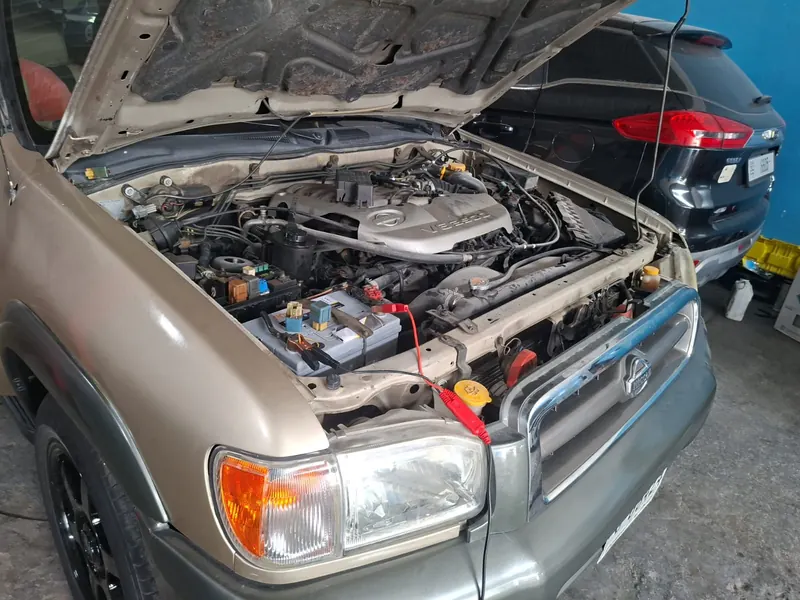 Open engine bay with battery and wiring visible